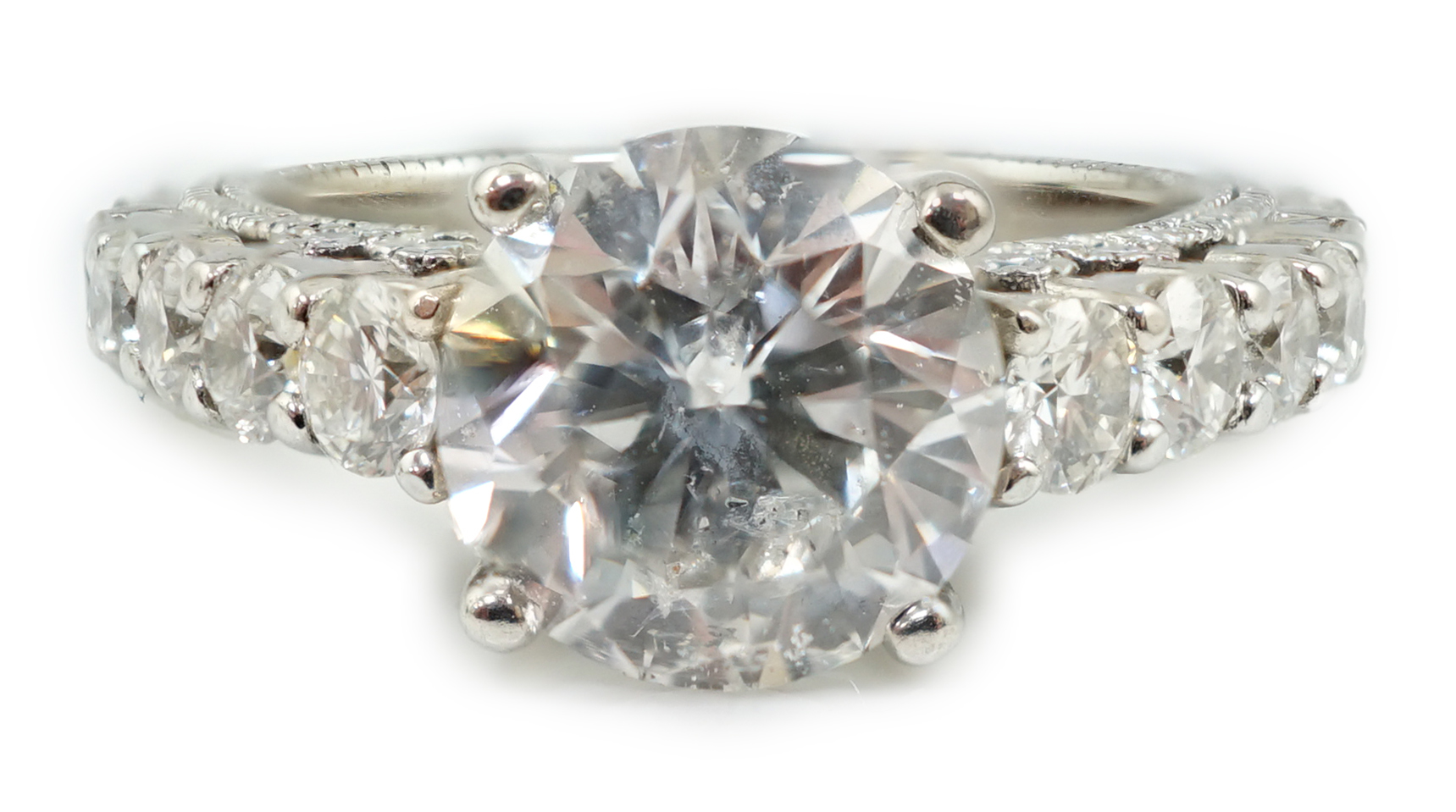A modern 18ct white gold and single stone diamond set ring, with twenty eight graduated diamond set shank and setting
